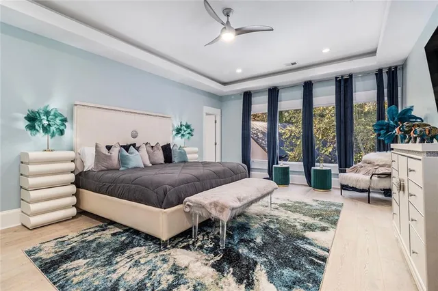 a spacious bathroom with a granite countertop sink a toilet and a bathtub