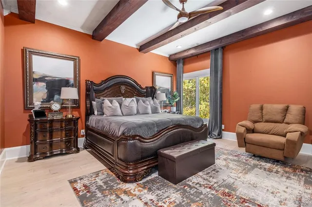 a bathroom with a granite countertop toilet sink and mirror