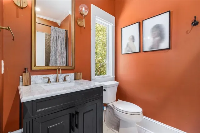 a bathroom with a toilet a sink and mirror