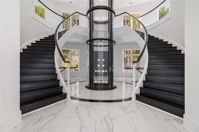 a living room with furniture and wall paintings