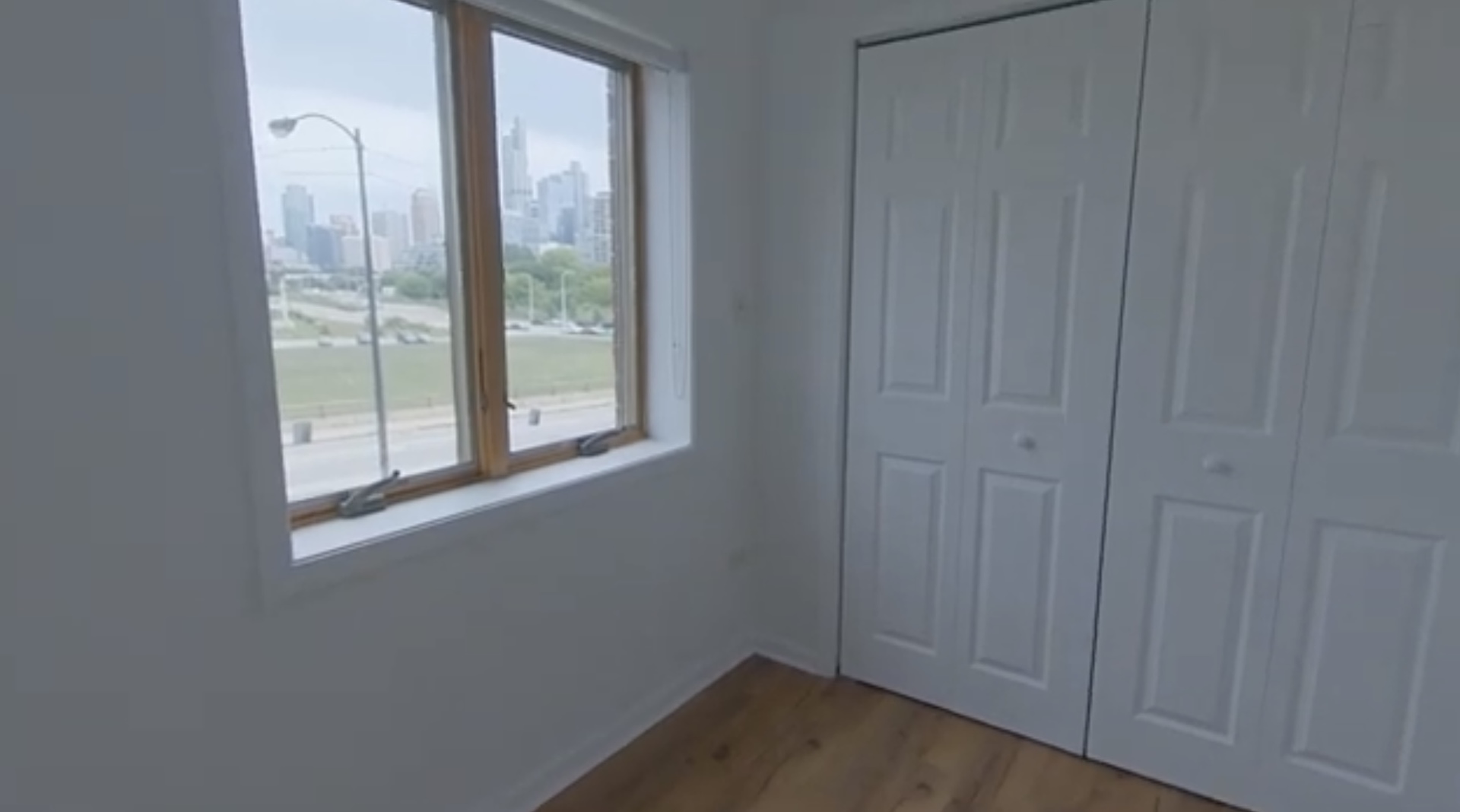 231 West 18th Street, Unit 2A Chicago, IL 60616 - Photo 6 of 9 a view of an empty room with wooden floor and windows