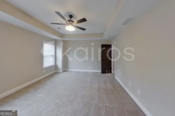 a view of a livingroom with a ceiling fan and window