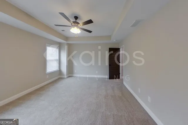a view of a livingroom with a ceiling fan and window
