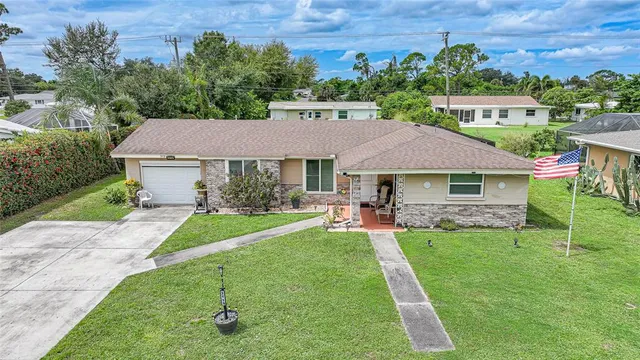 a aerial view of a house with a yard table and chairs
