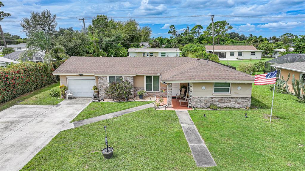 3119 Pinetree Street Port Charlotte, FL 33952 - Photo 1 of 23 a aerial view of a house with a yard table and chairs