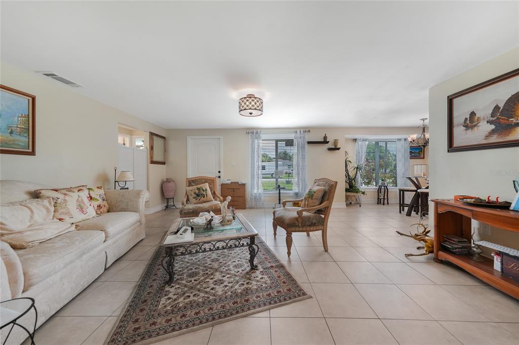 3119 Pinetree Street Port Charlotte, FL 33952 - Photo 11 of 23 a living room with furniture gym equipment and a rug