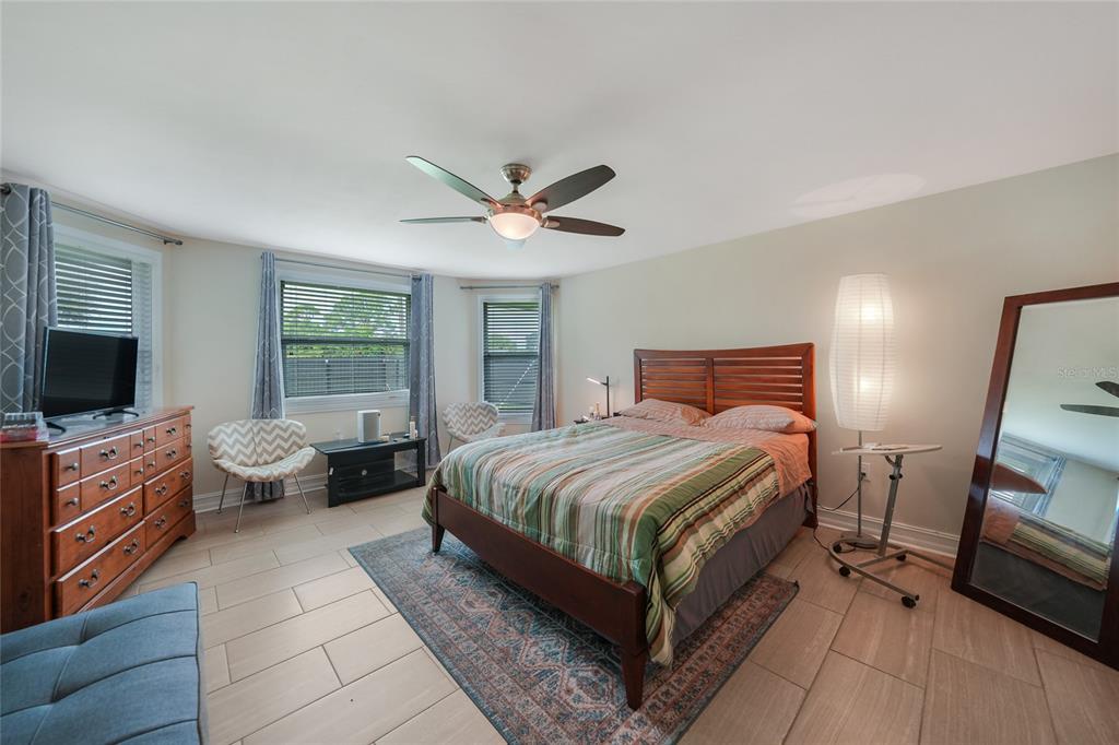 3119 Pinetree Street Port Charlotte, FL 33952 - Photo 12 of 23 a spacious bedroom with a bed a window and dresser