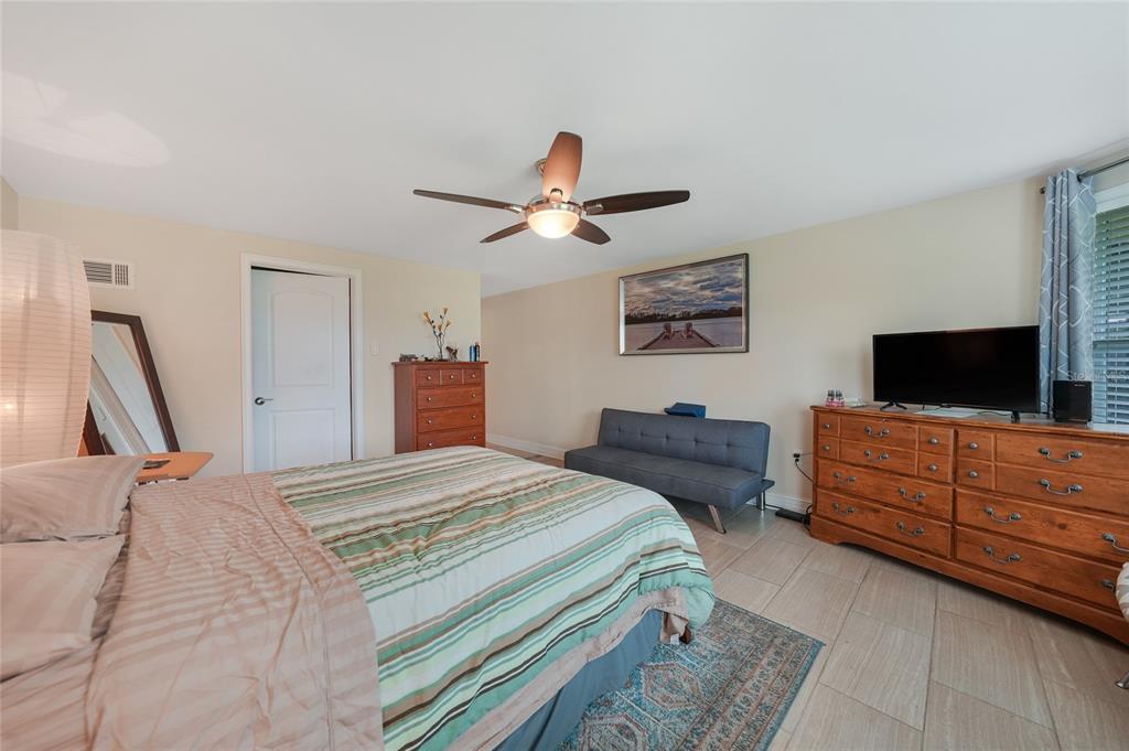 3119 Pinetree Street Port Charlotte, FL 33952 - Photo 14 of 23 a bedroom with a bed and a flat screen tv
