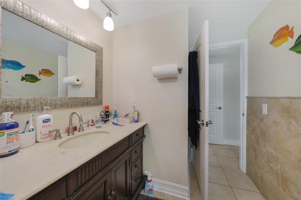 3119 Pinetree Street Port Charlotte, FL 33952 - Photo 16 of 23 a bathroom with a sink vanity granite and a mirror