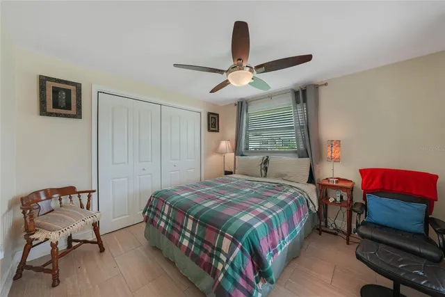 a bedroom with a bed a couch and a chandelier