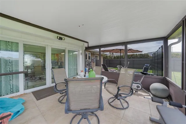 a living room with furniture and a floor to ceiling window