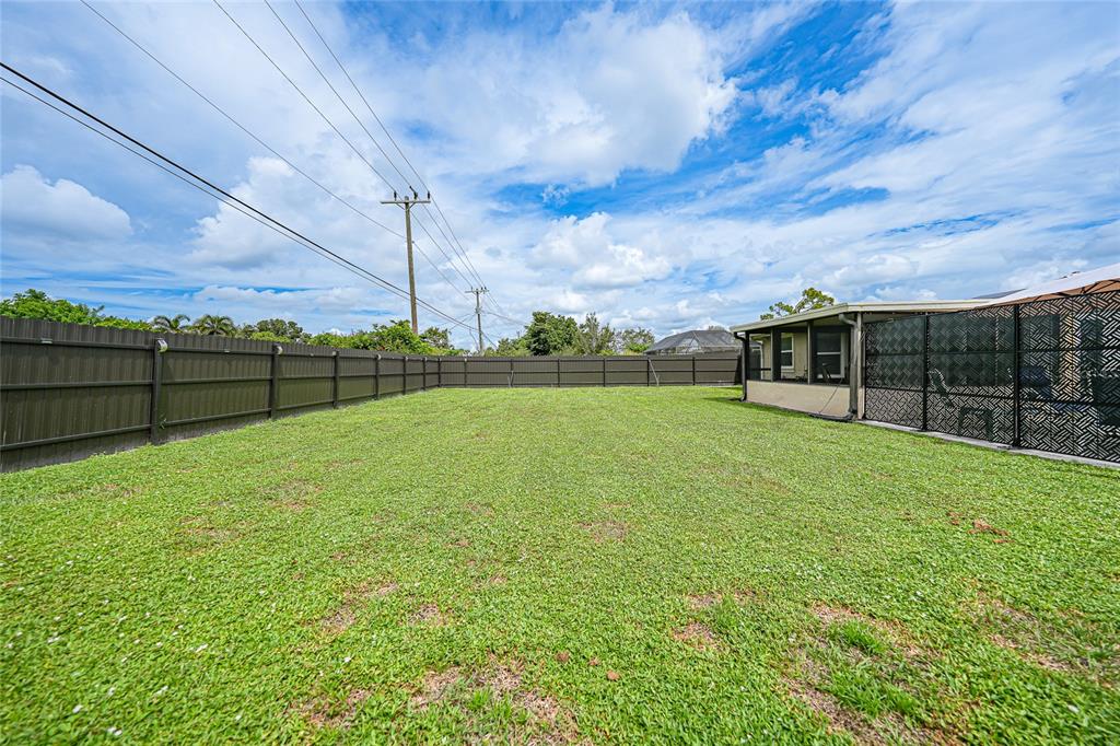 3119 Pinetree Street Port Charlotte, FL 33952 - Photo 3 of 23 a view of a yard with wooden fence