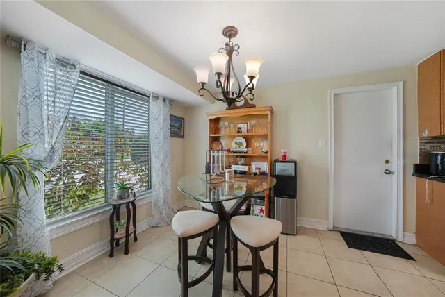 a view of a dining room with furniture and a chandelier