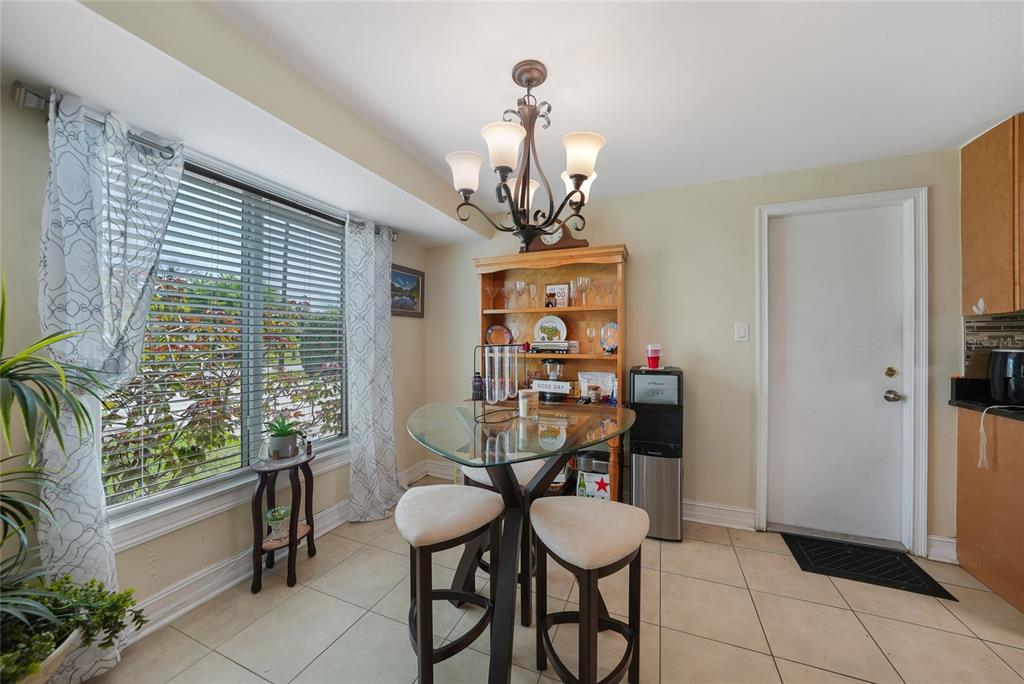 3119 Pinetree Street Port Charlotte, FL 33952 - Photo 5 of 23 a view of a dining room with furniture and a chandelier