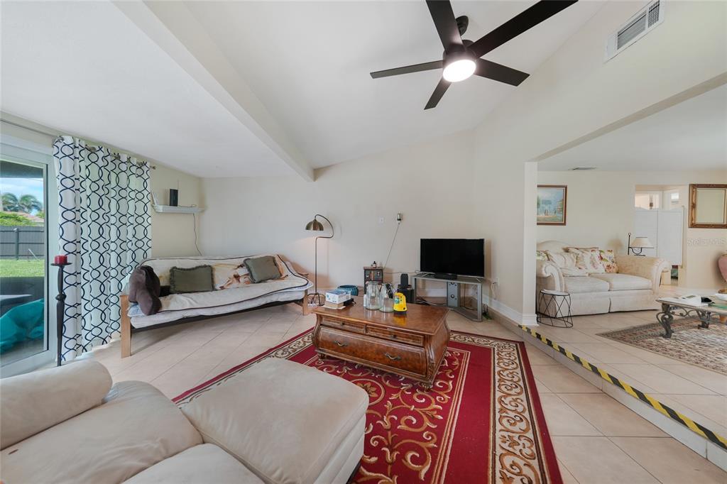3119 Pinetree Street Port Charlotte, FL 33952 - Photo 9 of 23 a living room with furniture and a flat screen tv
