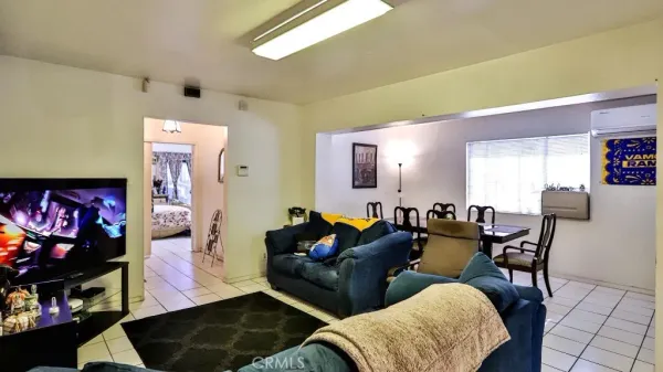 a dining room with furniture and a rug