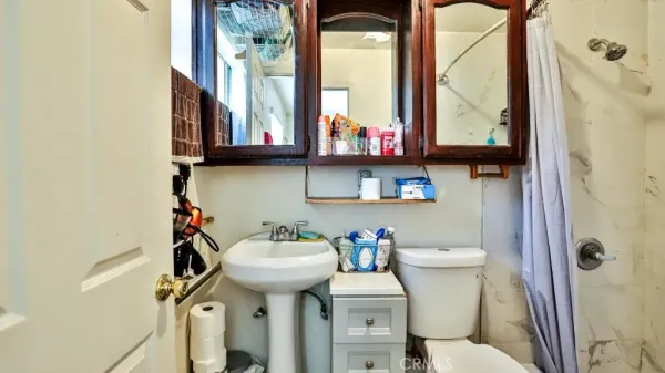 a bedroom with a bed and a dresser next to a window