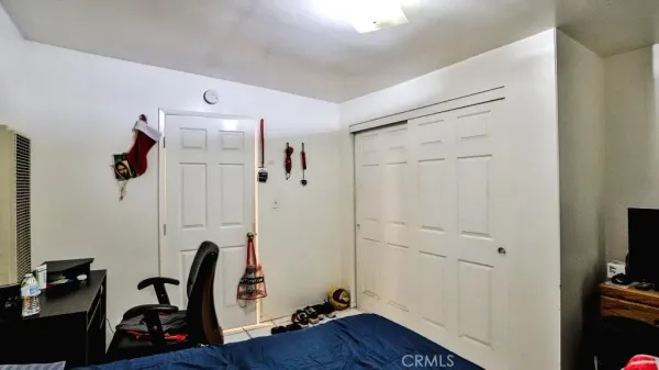 a bedroom with a bed and a tv