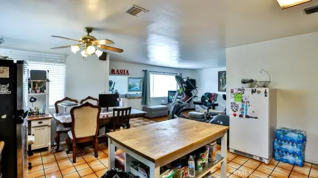 a open kitchen with stainless steel appliances granite countertop a stove and a refrigerator