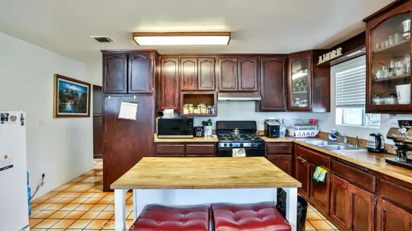 a kitchen with a dining table cabinets and appliances