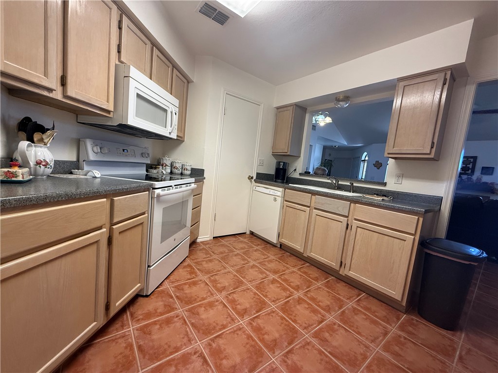 113 Santa Fe Rockport, TX 78382 - Photo 12 of 25 a kitchen with a sink stove and cabinets