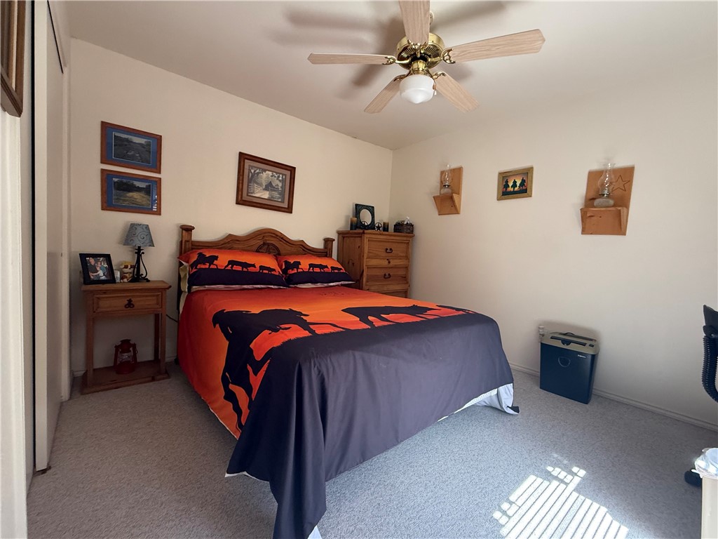 113 Santa Fe Rockport, TX 78382 - Photo 19 of 25 a bedroom with a bed and a chandelier