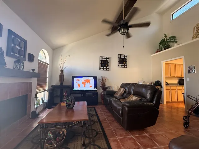 a living room with furniture a large window and a flat screen tv