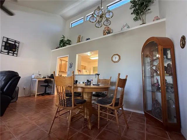 a view of a dining room and kitchen with a table and chairs