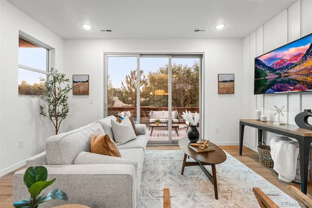 a living room with fireplace furniture and a large window