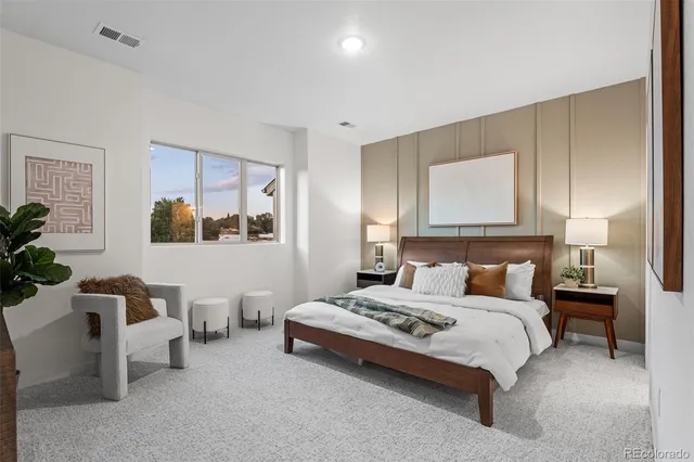 a bedroom with a bed and a night stand