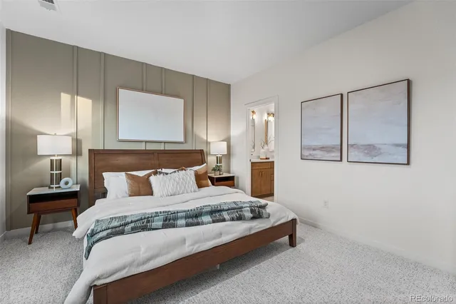 a bedroom with a bed a dresser and chair