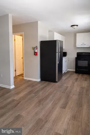 a view of a kitchen with refrigerator and a stove