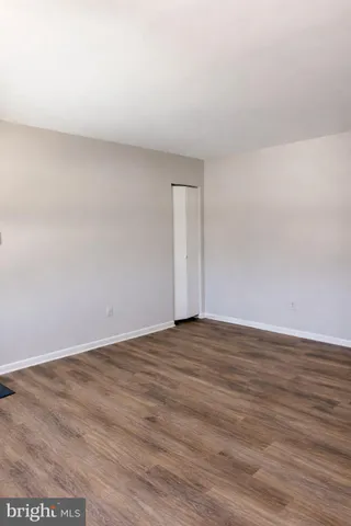 a view of an empty room and wooden floor