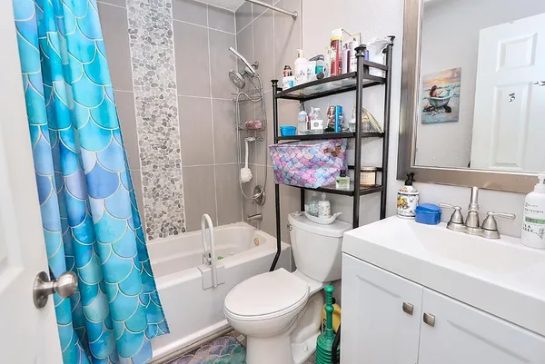 a bathroom with a sink toilet and a shower