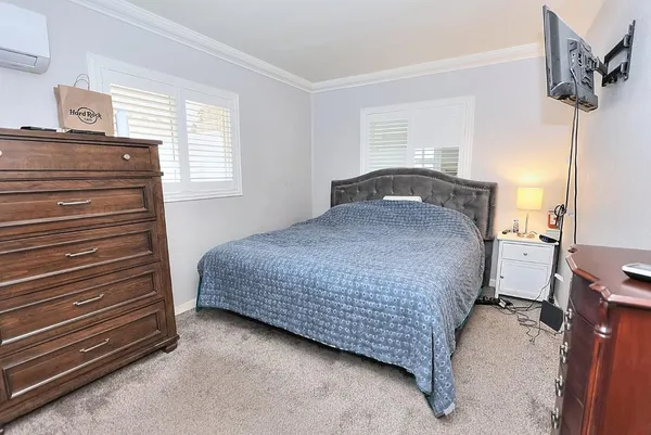 a bedroom with a bed and a night stand