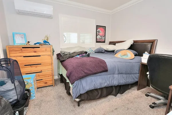 a bedroom with furniture and a window