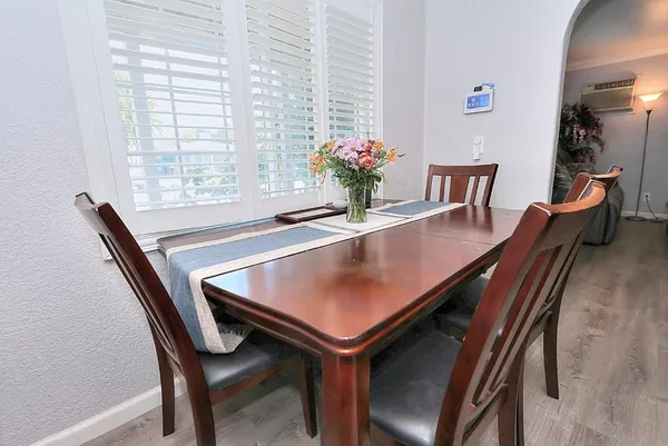 a dining room with furniture and window