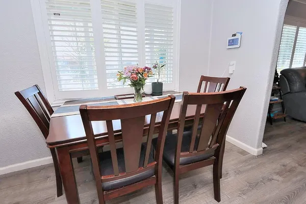 a view of a dining room with furniture and window