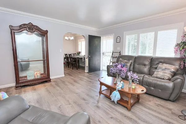 a living room with furniture and wooden floor