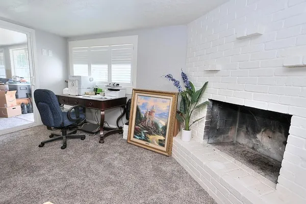 a workspace with furniture and a fireplace