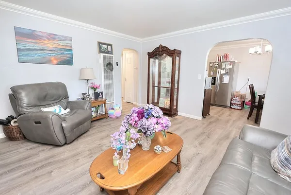 a living room with furniture and wooden floor
