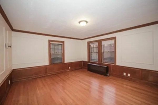 an empty room with windows and closet