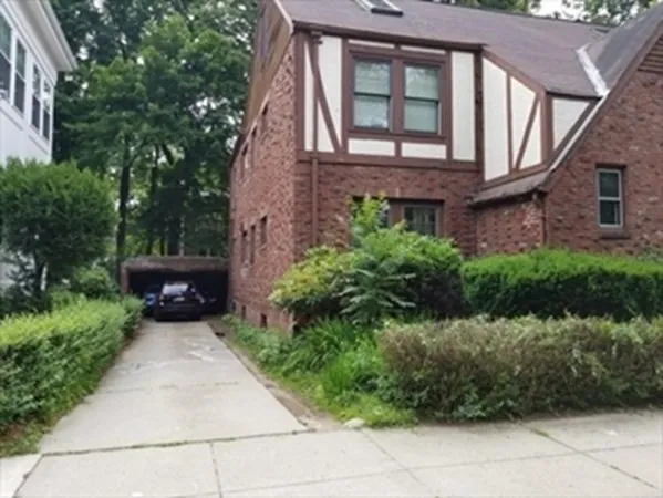 a front view of a house with a garden