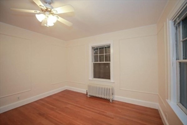 35 Greycliff Road, Unit 2 Boston, MA 02135 - Photo 21 of 26 a view of an empty room with a window and wooden floor