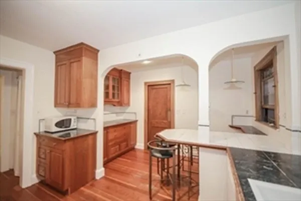 a kitchen with granite countertop a sink and cabinets