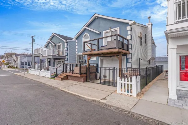 a view of a house with wooden fence