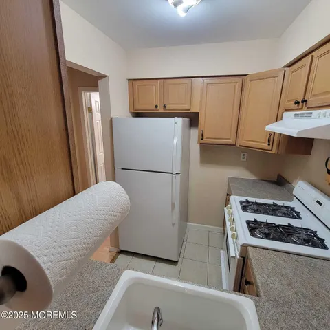 a kitchen with a refrigerator and a stove