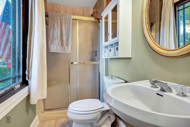 741 Longlane Road New Lenox, IL 60451 - Photo 14 of 28 a bathroom with a sink a toilet and a mirror