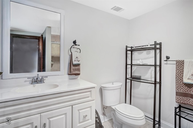 741 Longlane Road New Lenox, IL 60451 - Photo 20 of 28 a bathroom with a toilet a sink and a mirror