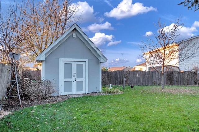741 Longlane Road New Lenox, IL 60451 - Photo 25 of 28 a view of a house with a yard and a garden